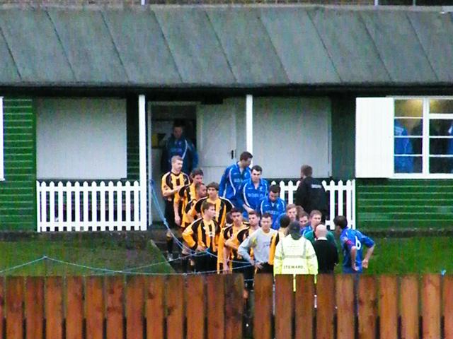 The teams come out the cricket pavillion