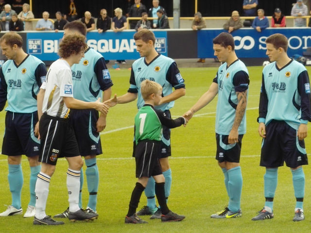 The teams shake hands