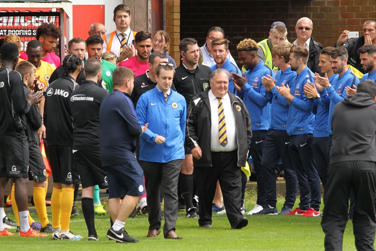 John Blackwell leads the teams out